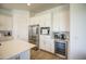 Close-up view of white kitchen cabinets, stainless steel appliances, and built-in wine cooler at 9845 E Thistle Ave, Mesa, AZ 85212