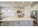Bright kitchen with white cabinets, a large island, subway tile backsplash, and stainless steel appliances at 9845 E Thistle Ave, Mesa, AZ 85212