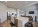 Kitchen island with stainless steel appliances, white cabinets, and modern decor opening to living space at 9845 E Thistle Ave, Mesa, AZ 85212