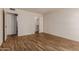 Neutral bedroom with wood look floors, closet, and white paint at 9929 W Thunderbird Blvd, Sun City, AZ 85351