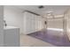 Garage with white painted storage cabinets along the wall for extra storage space at 9929 W Thunderbird Blvd, Sun City, AZ 85351