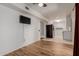 Open-concept space with hard wood floors, neutral paint, and connected updated kitchen at 9929 W Thunderbird Blvd, Sun City, AZ 85351