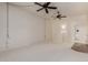 Large living room with neutral carpet, wood-look flooring, and minimalist design at 9929 W Thunderbird Blvd, Sun City, AZ 85351