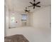 Spacious living room featuring neutral carpet, wood look flooring, multiple ceiling fans and bright natural light at 9929 W Thunderbird Blvd, Sun City, AZ 85351
