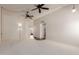 Bright living room with neutral carpet, vaulted ceilings, decorative lighting and updated flooring in entryways at 9929 W Thunderbird Blvd, Sun City, AZ 85351