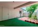 Shaded patio area with turf and brick pavers for outdoor living at 9929 W Thunderbird Blvd, Sun City, AZ 85351