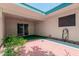Covered patio featuring a brick paver area, artificial grass, and a slider door at 9929 W Thunderbird Blvd, Sun City, AZ 85351