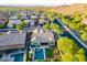 Beautiful aerial view of home with pool, lush landscaping, and views of surrounding desert landscape at 10207 W Hedge Hog Pl, Peoria, AZ 85383