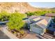 Stunning aerial view of the home with desert landscaping, tile roof, and paver driveway at 10207 W Hedge Hog Pl, Peoria, AZ 85383