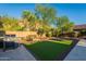 Beautiful backyard with an outdoor grill and verdant artificial grass at 10207 W Hedge Hog Pl, Peoria, AZ 85383