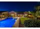 Night shot of backyard featuring pool, integrated hot tub, patio and lounge area at 10207 W Hedge Hog Pl, Peoria, AZ 85383