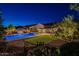 Expansive backyard featuring a pool, spa, covered patio, and lush landscaping for outdoor living at 10207 W Hedge Hog Pl, Peoria, AZ 85383