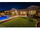 Beautiful backyard with sparkling pool, covered patio, and manicured landscaping, ideal for entertaining at 10207 W Hedge Hog Pl, Peoria, AZ 85383