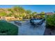 Inviting backyard with a pool, spa, patio dining area, and lush landscaping at 10207 W Hedge Hog Pl, Peoria, AZ 85383