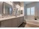 This full bath features dual sinks, granite counters, modern fixtures, and a soaking tub at 10207 W Hedge Hog Pl, Peoria, AZ 85383
