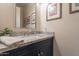 Stylish powder room features granite counters, vanity with storage, and decorative mirror at 10207 W Hedge Hog Pl, Peoria, AZ 85383
