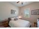 Cozy bedroom with neutral walls, carpet, and light shutters at 10207 W Hedge Hog Pl, Peoria, AZ 85383