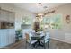 Eat-in kitchen area featuring a round dining table, modern chandelier, and lots of natural light at 10207 W Hedge Hog Pl, Peoria, AZ 85383