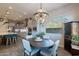 Eat-in dining area features stylish light fixture, wood floors, a large window, and access to the kitchen at 10207 W Hedge Hog Pl, Peoria, AZ 85383