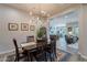 This dining room has a wooden table and leads into the kitchen and living room at 10207 W Hedge Hog Pl, Peoria, AZ 85383