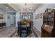 This dining room features a stylish chandelier, a wooden table, and a blue patterned rug at 10207 W Hedge Hog Pl, Peoria, AZ 85383