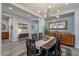 Formal dining room featuring decorative chandelier and built in shelving at 10207 W Hedge Hog Pl, Peoria, AZ 85383