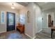 Entryway with decorative wrought iron front door, wood bench and tile flooring at 10207 W Hedge Hog Pl, Peoria, AZ 85383