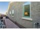 Home exterior featuring stucco walls, a brick walkway, and multiple windows for ample natural light at 10207 W Hedge Hog Pl, Peoria, AZ 85383