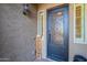 Intricate wrought iron front door with side windows and welcome sign at 10207 W Hedge Hog Pl, Peoria, AZ 85383