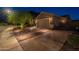Wide driveway leading to a two car garage and landscaped yard at 10207 W Hedge Hog Pl, Peoria, AZ 85383