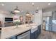 Open concept kitchen featuring a center island with a farmhouse sink and pendant lights at 10207 W Hedge Hog Pl, Peoria, AZ 85383