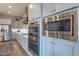 Kitchen with stainless steel appliances, double oven, microwave, and gray cabinets at 10207 W Hedge Hog Pl, Peoria, AZ 85383