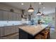 Spacious kitchen with large island, pendant lights, and stainless steel appliances at 10207 W Hedge Hog Pl, Peoria, AZ 85383