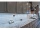 Gourmet kitchen featuring granite countertops, white subway tile backsplash, and ample cabinet space at 10207 W Hedge Hog Pl, Peoria, AZ 85383