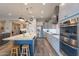 Bright kitchen with large center island, pendant lighting, and stainless steel appliances at 10207 W Hedge Hog Pl, Peoria, AZ 85383