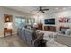 Comfortable living room with soft gray furniture, stylish wall accents, and ample natural light at 10207 W Hedge Hog Pl, Peoria, AZ 85383