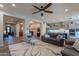 Spacious living room with an open floor plan and a view of the entryway and kitchen at 10207 W Hedge Hog Pl, Peoria, AZ 85383