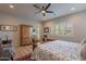 Spacious main bedroom features wood floors, ceiling fan, area rug, door to patio, and shutters at 10207 W Hedge Hog Pl, Peoria, AZ 85383