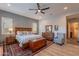 Spacious main bedroom features wood floors, ceiling fan, area rug, and nice furniture at 10207 W Hedge Hog Pl, Peoria, AZ 85383
