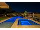 Inviting backyard pool and spa with ambient lighting and lounge area, perfect for evening relaxation at 10207 W Hedge Hog Pl, Peoria, AZ 85383