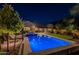 Expansive backyard featuring a modern pool, spa, outdoor seating, and manicured landscaping at 10207 W Hedge Hog Pl, Peoria, AZ 85383