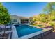 Backyard oasis featuring a pool, spa, and lush greenery, providing a serene escape at 10207 W Hedge Hog Pl, Peoria, AZ 85383