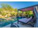 Backyard pool area with a covered daybed for outdoor relaxation at 10207 W Hedge Hog Pl, Peoria, AZ 85383