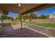 Covered patio and backyard featuring a well-maintained lawn and block wall at 10318 E Michigan Ave, Sun Lakes, AZ 85248