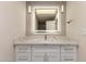 Elegant bathroom vanity featuring quartz countertop, sleek gold hardware and modern, illuminated mirror at 10318 E Michigan Ave, Sun Lakes, AZ 85248