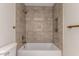 Stylish bathroom with tiled shower and tub, featuring a built-in niche and sleek fixtures at 10318 E Michigan Ave, Sun Lakes, AZ 85248