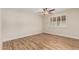 Well-lit bedroom featuring hard wood flooring, a modern ceiling fan, and light paint at 10318 E Michigan Ave, Sun Lakes, AZ 85248
