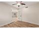 Bedroom with hardwood floors, ceiling fan, and access to another room through elegant French doors at 10318 E Michigan Ave, Sun Lakes, AZ 85248
