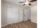 Bedroom with hardwood floors, ceiling fan, and large closets at 10318 E Michigan Ave, Sun Lakes, AZ 85248