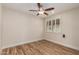 This airy bedroom is complete with hardwood floors, a ceiling fan, and a window for natural light at 10318 E Michigan Ave, Sun Lakes, AZ 85248